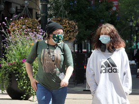 Katrin Bradshaw and Gianna Reid are seen walking along Stephen Ave. SW wearing masks on a warm afternoon. Monday, August 10, 2020.