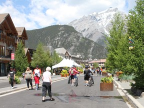 Tourists and residents walk through a closed-off section of Banff Avenue on June 20, 2020. A Kentucky man faces charges after he detoured to Banff, breaking Canada's quarantine rules.