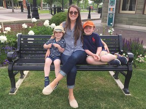 Jessica Cuillerier, with her two boys, says she's worried about whether she should send them back to the Catholic school district classrooms this fall.