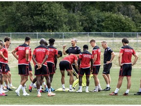 Cavalry FC coach and GM Tommy Wheeldon Jr (C) speaks to his team in a team huddle during training in Prince Edward Island at the Canadian Premier League Island Games. David Chant photo/CPL