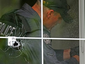 Police remove a bullet from a wall inside a home after an early morning shooting scene in Altadore on June 24, 2020. At least two vehicles and three homes were hit by gunfire along 21A Street S.W.