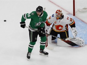 Aug 11, 2020; Edmonton, Alberta, CAN; The puck goes wide of Dallas Stars left wing Roope Hintz (24) and Calgary Flames goaltender Cam Talbot (39) during the third period in game one of the first round of the 2020 Stanley Cup Playoffs at Rogers Place. Mandatory Credit: Perry Nelson-USA TODAY Sports ORG XMIT: USATSI-429677