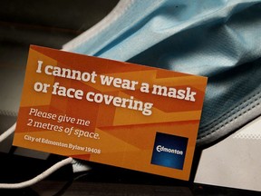 A City of Edmonton face mask exemption card, in Edmonton Monday Aug. 10, 2020. In response to COVID-19 a City of Edmonton bylaw requiring people to wear face masks in all public indoor spaces went into effect Aug. 1, 2020. However, the city has begun issuing face mask exemption cards at Edmonton recreation centres. Photo by David Bloom