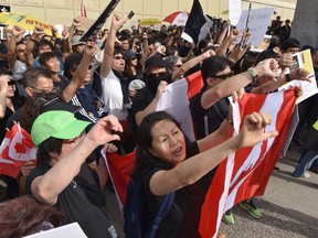 Pro Hong Kong supporters shout at pro-China supporters during a rally at the Broadway-City Hall SkyTrain Station in Vancouver, Canada on August 17, 2019.