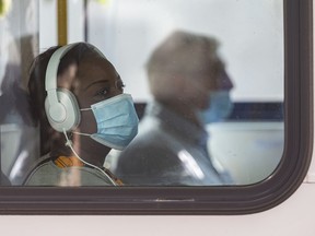 A passenger uses a Calgary transit bus while wearing a mask on Friday, September 4, 2020.