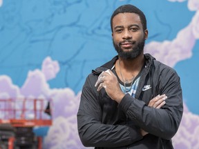 Calgary Artist Jae Sterling poses for a photo in front of his unfinished mural in Chinatown on Saturday, September 5, 2020. Sterling's mural, a part of Pink Flamingo's BLM murals, aims to celebrate black culture.  Azin Ghaffari/Postmedia