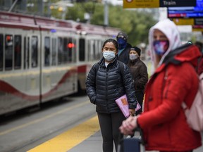 Passengers wait for the train wearing face masks at City Hall station on Tuesday, September 15, 2020.
