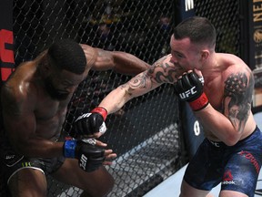 Colby Covington punches Tyron Woodley in their welterweight bout during the UFC Fight Night event at UFC APEX on Sept. 19, 2020 in Las Vegas. Zuffa/LLC via Getty Images