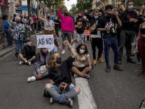 MADRID, SPAIN - SEPTEMBER 20: Protesters wearing protective masks shout slogans as one holds a placard reading 'Not that way' during a demonstration, in the Vallecas neighborhood, against the measures imposed by the Madrid regional government on areas with the most COVID-19 cases on September 20, 2020 in Madrid, Spain. Spain is the midst of a second wave of COVID-19, reporting more than 122,000 new cases in the last two weeks. More than a third are in the Madrid region.