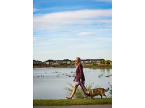 Kristen McMullen walks her dog Nico as they enjoy the beautiful weather in Midtown's central park in Airdrie.