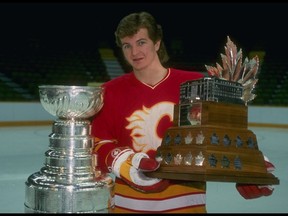 Calgary Flames defenceman Al MacInnis poses with the Stanley Cup and the Conn Smythe Trophy, right. MacInnis won the Conn Smythe award as the MVP of the playoffs for leading his Flames to a 4-2 series victory over the Montreal Canadiens. DK Photo/Getty Images