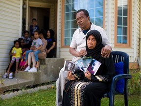 Khalid and Hanan Shaikh hold pictures of their son Mohamed Shaikh, 19, one of the victims of the Aug. 28 Sandstone triple shooting outside their Calgary home on Thursday, September 3, 2020.