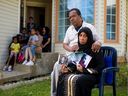 Khalid and Hanan Shaikh hold photos of their son Mohamed Shaikh, 19, one of the victims of the Aug. 28 Sandstone triple shooting outside their home in Calgary on Thursday, Sept. 3, 2020.