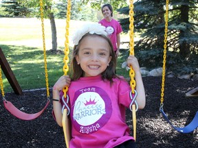 Five-year old Alysha swings with her mom Robin Somji at their Springbank home. Alysha has been living with a kidney disease for years and the family have become acting fundraisers for research for the disease.