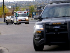 Calgary police escort EMS to the Children's Hospital after a young kid fell from a two-story condo off Hidden Creek Boulevard in Calgary on Tuesday, September 22, 2020.