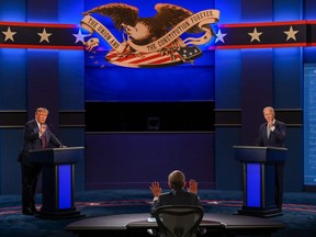 U.S. President Donald Trump and Democratic Presidential candidate and former U.S. Vice President Joe Biden exchange arguments as moderator and Fox News anchor Chris Wallace (C) raises his hands to stop them during the first presidential debate at in Cleveland, Ohio, on September 29, 2020.