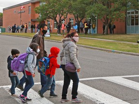 Students and parents head to the first day of class at St. Margaret School in Calgary on Wednesday, September 2, 2020.