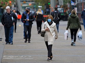 Calgarians walk in downtown Calgary on a cool day, Monday, Sept. 14, 2020.