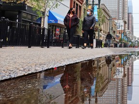 Calgarians wearing masks walk in downtown Calgary on a cool day, Monday, September 14, 2020.