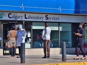 Calgarians wait to enter the Sunridge lab services location for medical testing on Thursday, September 24, 2020.