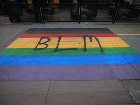 A Pride flag street painting on Stephen Avenue Mall in Calgary is seen with BLM letters spray painted on it on Monday, September 28, 2020.