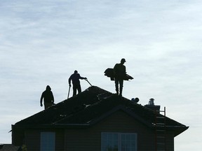 Roofers work in the northeast community of Saddleridge in Calgary on Tuesday, Sept. 29, 2020.