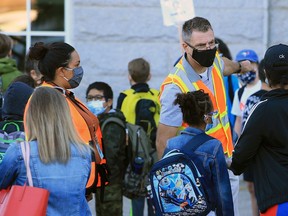 Students at Stanley Jones School wait for the bell on Tuesday, September 1, 2020. It was the first day for Calgary Board of Education students starting back amidst the COVID-19 pandemic.