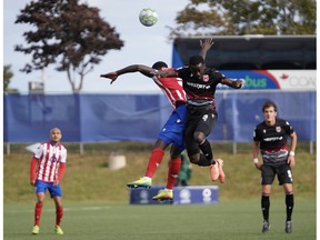 Canadian Premier League - Atletico Ottawa vs Cavalry FC - Charlottetown, PEI- Aug 27, 2020]. Cavalry FC #3 Nathan Mavila battles for the ball.