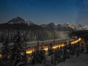A cargo train passes through Alberta's Banff National Park in a file photo from Dec. 2, 2013. A proposed Alaska-to-Alberta (A2A) rail line would carry Albertan oil to Alaskan ports.