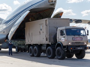 Russian servicemen load medical equipment and special disinfection vehicles into cargo planes while sending the supply to Italy, hit by the outbreak of coronavirus disease (COVID-19), at a military airdrome in Moscow region, Russia March 22, 2020.