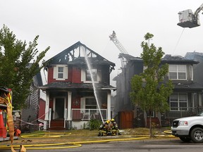 Calgary firefighters battle a blaze that destroyed two homes and damaged two others on Evanston Drive N.W. on Tuesday, Sept. 8, 2020.