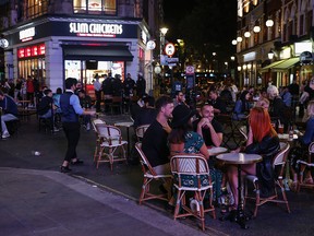 Patrons are served at temporary outdoor seating areas in London's Soho district on Sept. 19, 2020.