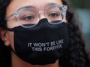 A masked demonstrator takes part in a protest against police brutality in Boston, Massachusetts, on Sept. 9, 2020.