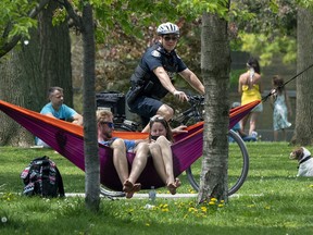 A bicycle police officer patrols Trinity Bellwoods Park in Toronto on May 24, 2020.
