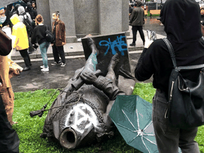 A statue of Sir John A. Macdonald, Canada’s first prime minister, lies on the ground after it was pulled down during a protest against racial inequality in Montreal on August 29, 2020.