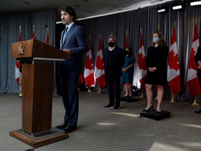 Prime Minister Justin Trudeau, with cabinet ministers behind, speaks to media following a cabinet retreat in Ottawa, on Sept. 16, 2020.