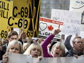 Opponents of Bill C-69 rally outside a public hearing of the Senate committee on energy, the environment and natural resources in Calgary in April 2019.