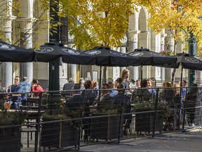 Calgarians spend their lunch time on a restaurant patio on Stephen Avenue on Monday, Oct. 5, 2020.