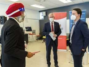 Dr. Baljit Singh, dean of University of Calgary's Faculty of Veterinary Medicine, left, Edward McCauley, University of Calgary president and vice-chancellor, and Devin Dreeshen, Minister of Agriculture and Forestry, have a conversation at the media event announcing new fundings on Wednesday, October 14, 2020.