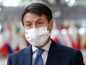 Italian Prime Minister Giuseppe Conte, wearing a face mask, arrives on the second day of a two days face-to-face EU summit, in Brussels, on October 16, 2020.