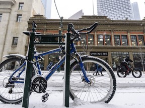 FILE - People commute on Stephen Avenue on a snowy morning on Wednesday, October 21, 2020.