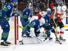 Matthew Tkachuk of the Calgary Flames tries to put a backhand shot past goalie Jacob Markstrom of the Vancouver Canucks during NHL action at Rogers Arena on Feb. 8, 2020 in Vancouver. Rich Lam/Getty Images