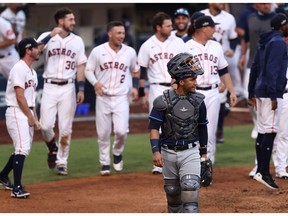 SAN DIEGO, CALIFORNIA - OCTOBER 15: Michael Perez #7 of the Tampa Bay Rays looks on as the Houston Astros celebrates a Carlos Correa #1 of the Houston Astros walk off solo home run to win 4-3 in Game Five of the American League Championship Series at PETCO Park on October 15, 2020 in San Diego, California.