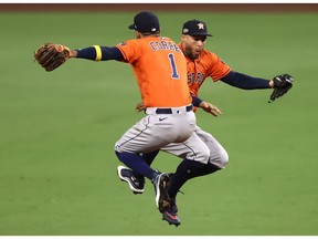 SAN DIEGO, CALIFORNIA - OCTOBER 16: Carlos Correa #1 and George Springer #4 of the Houston Astros celebrate a 7-4 win against the Tampa Bay Rays in Game Six of the American League Championship Series at PETCO Park on October 16, 2020 in San Diego, California.