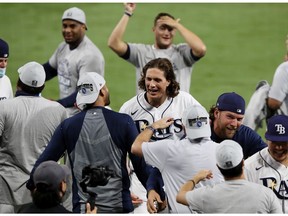SAN DIEGO, CALIFORNIA - OCTOBER 17: Members of the Tampa Bay Rays celebrate a 4-2 win against the Houston Astros to win the American League Championship Series at PETCO Park on October 17, 2020 in San Diego, California.