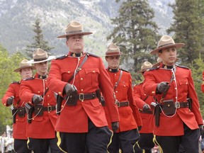 FILE - Members of the Canmore RCMP dressed in their ceremonial red serge march down Main Street in Canmore during a Canada Day parade. The provincial government is discussing creating a provincial police force to replace the RCMP.