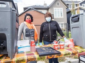 Alia Azim Garcia, left, and Bim Olawumi serve up goodies at a Thanksgiving long table event in Legacy on Oct. 10, 2020.