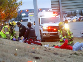 Calgary police and fire tend to victims involved in a car accident after a gravel truck hit a car on McKnight Tr. and Barlow Tr. N.E. The gravel truck driver had to be cut out of his vehicle in Calgary on Tuesday, October 13, 2020.