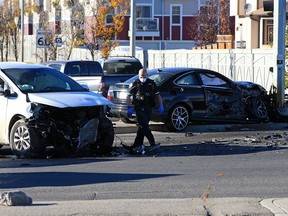A Calgary EMS paramedic walks near the scene of a serious two-vehicle collision at the intersection of 52nd Street and McIvor Boulevard S.E. on Sunday, October 11, 2020.