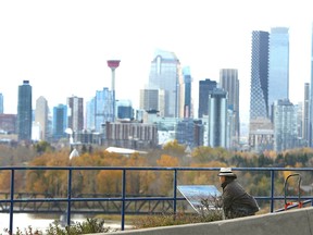 Artist An Dong paints near Barlow Tr and Memorial Drive SE overlooking Deerfoot Tr and downtown Calgary on Thursday, October 15, 2020.